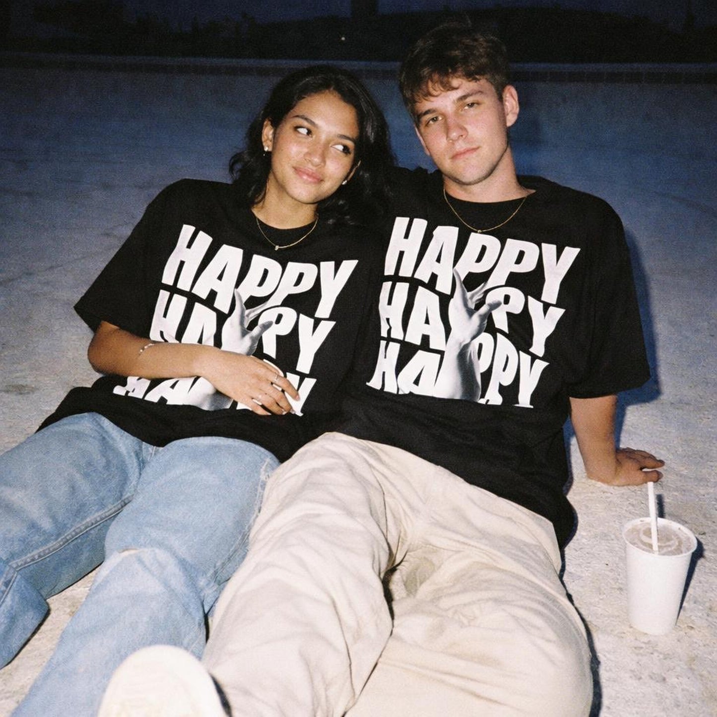 Happy | Oversized T-Shirt | Black · on a man and a woman